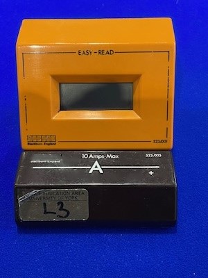 an orange and black box sitting on top of a blue surface with a number on the front of it