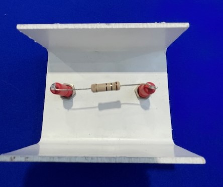 a pair of red and white earbuds sitting in a white box on a blue surface with a blue background